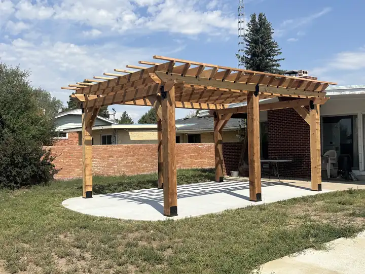 Cedar pergola on a new concrete slab in a backyard
