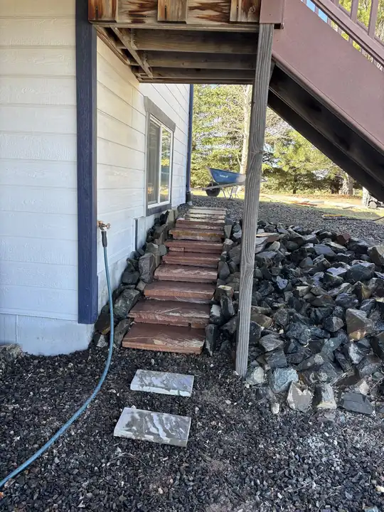 Exterior stairs beside a rock bed