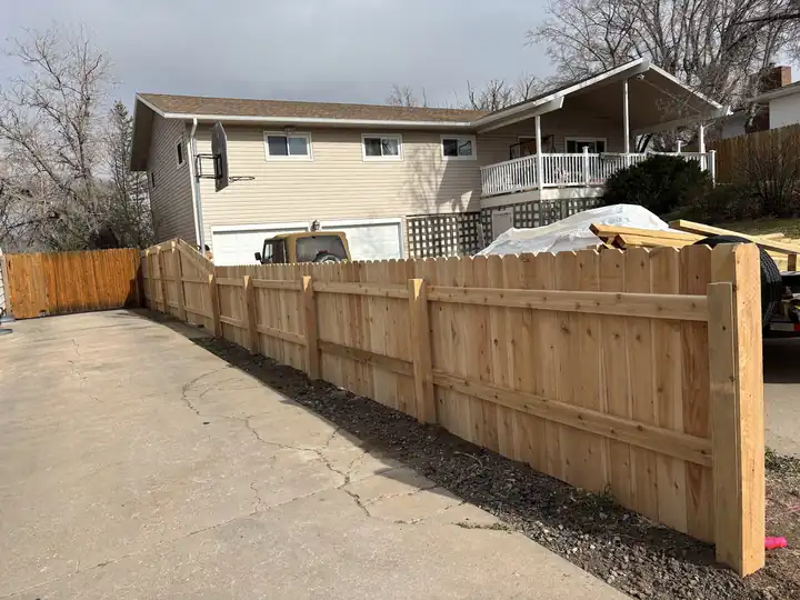 New cedar fence along the side of a house