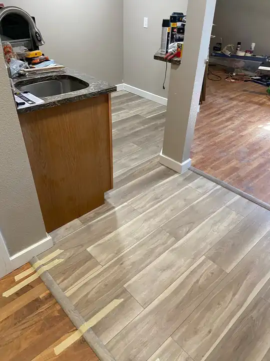 Laminate floor running through a kitchen