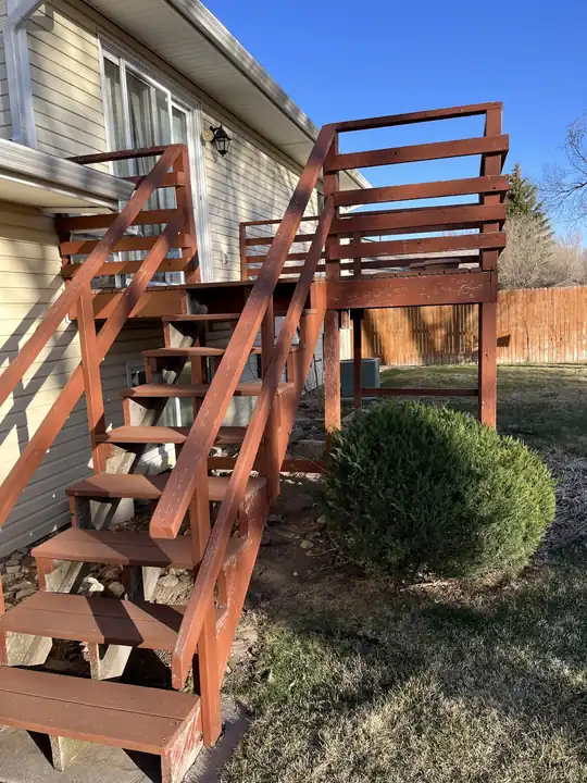 Exterior deck stairs and rails stained a deep red-brown